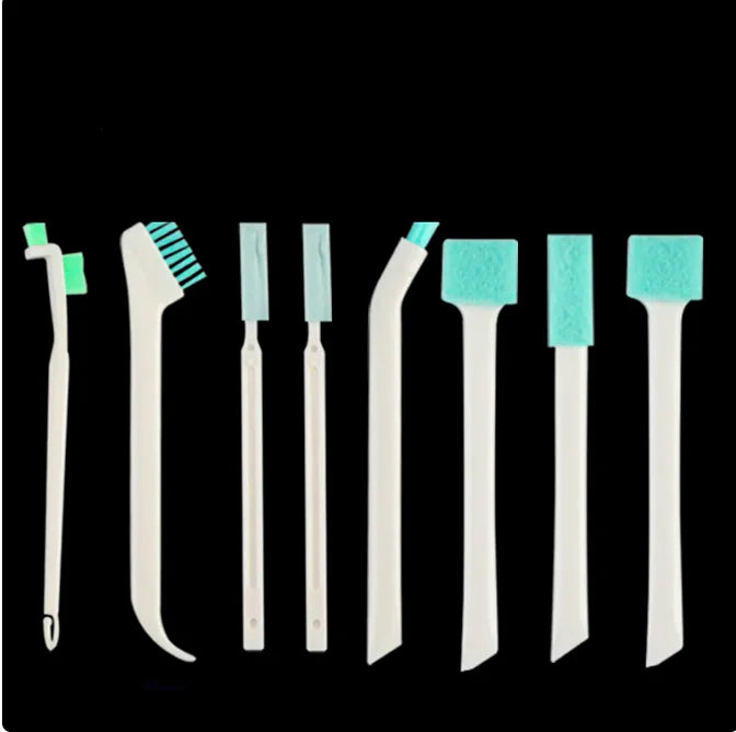 Narrow cleaning brush being used to scrub hard-to-reach kitchen crevices, showing efficiency in tight spaces.
