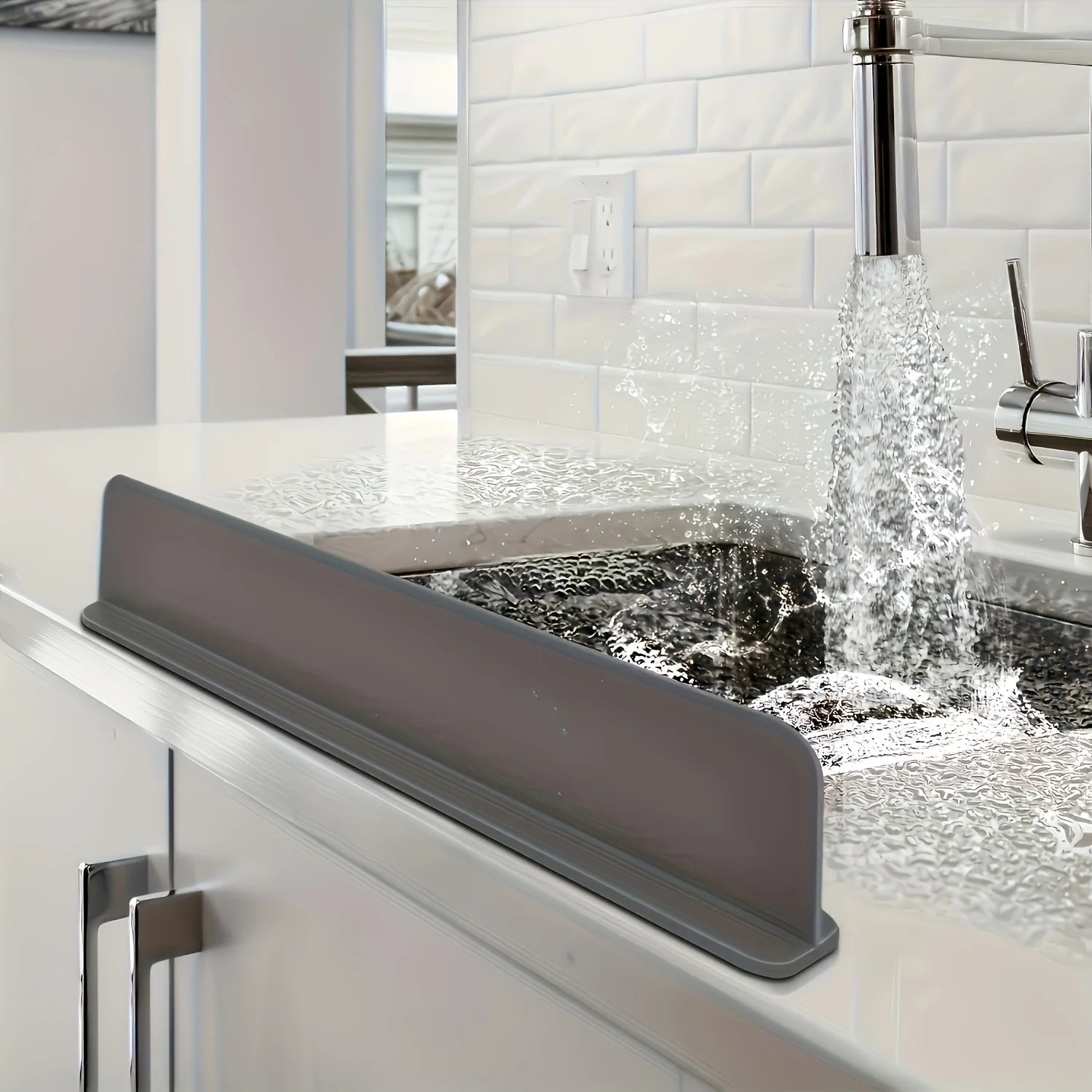Silicone sink splash guard and flexible water barrier protecting countertop from splashes.
