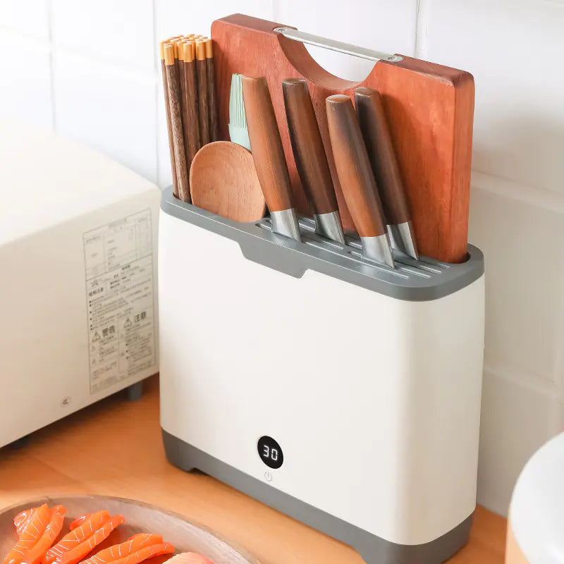 Close-up of the UV-C light sterilizing kitchen tools, emphasizing the sanitization function.
