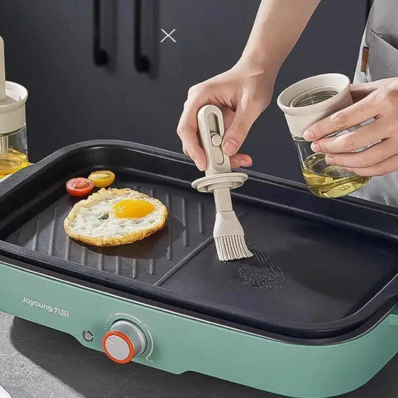 Silicone oil brush bottle in use, applying oil evenly on BBQ grill for perfect grilling.
